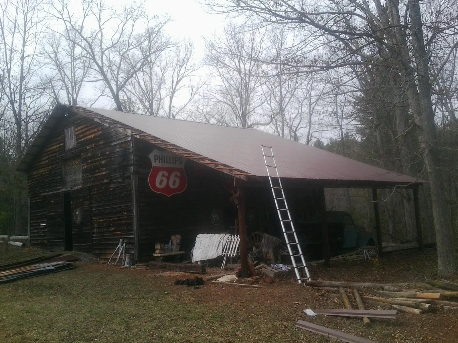 New metal roof on an open sided timber barn with a vintage sign in Ralph